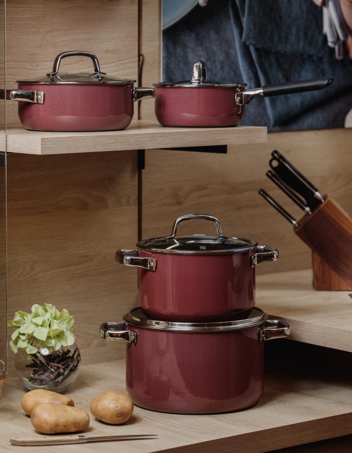 side view of cooking set of pots and pans on wooden shelves jpg